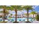 Community pool with lounge chairs and palm trees at 2553 Shanti Dr, Kissimmee, FL 34746