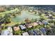 Aerial view of houses near a lake and golf course at 256 Largo Dr, Kissimmee, FL 34759