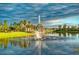 Community fountain with palm trees and lake view at 256 Largo Dr, Kissimmee, FL 34759