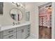Modern bathroom with gray vanity, a large mirror, and white countertop at 333 N Spaulding Cv, Lake Mary, FL 32746