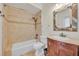 Clean bathroom with beige tile, a shower/tub combo, and wood vanity at 333 N Spaulding Cv, Lake Mary, FL 32746