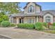 Two story house with gray siding, brown roof, and manicured landscaping at 333 N Spaulding Cv, Lake Mary, FL 32746