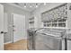 Convenient laundry room with modern washer and dryer, and built in shelving at 333 N Spaulding Cv, Lake Mary, FL 32746
