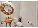 Small powder room with decorative mirror and stone sink at 333 N Spaulding Cv, Lake Mary, FL 32746