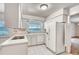 Kitchen with white cabinets, appliances, and lake view at 3651 S Rosalind Ave, Orlando, FL 32806