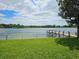 Peaceful lakefront view with a dock and grassy area at 3651 S Rosalind Ave, Orlando, FL 32806
