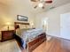 Bright bedroom with wood floors and ensuite bathroom access at 823 Elm Forest Dr, Minneola, FL 34715