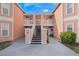 Exterior view of building entrance with stairs and landscaping at 8709 Rockingham Ter # A, Kissimmee, FL 34747