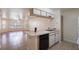 Kitchen with white cabinets, appliances, and view into living room at 8709 Rockingham Ter # A, Kissimmee, FL 34747