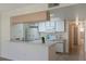 View of kitchen with white cabinets, appliances, and breakfast bar at 8709 Rockingham Ter # A, Kissimmee, FL 34747