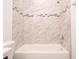 Clean bathtub with marble-style wall tile at 17406 Sw 38Th Avenue Rd, Ocala, FL 34473