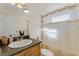 Clean bathroom with a shower/tub combo and granite vanity at 20106 Sunset Landing Ave, Groveland, FL 34736