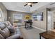 Comfortable bonus room with couch and home office setup at 20106 Sunset Landing Ave, Groveland, FL 34736