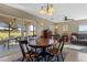 Dining room with wooden table and chairs, leading to a patio at 20106 Sunset Landing Ave, Groveland, FL 34736