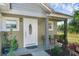 Inviting front porch with seating area and landscaping at 20106 Sunset Landing Ave, Groveland, FL 34736