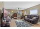 Spacious living room with leather reclining sofa and large TV at 20106 Sunset Landing Ave, Groveland, FL 34736