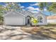 Gray house with a two-car garage and landscaping at 2080 Cobblefield Cir, Apopka, FL 32703