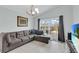 Living room with L-shaped sofa and sliding glass doors leading to the backyard at 2080 Cobblefield Cir, Apopka, FL 32703