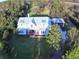 White farmhouse on large lot with mature trees at 2293 Eldorado Ct, St Cloud, FL 34771