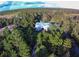 White farmhouse nestled in lush green landscape at 2293 Eldorado Ct, St Cloud, FL 34771