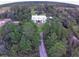 White farmhouse with long driveway, surrounded by trees at 2293 Eldorado Ct, St Cloud, FL 34771