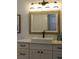 Bathroom with vanity, sink, and rustic-style mirror at 2293 Eldorado Ct, St Cloud, FL 34771