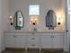 Double vanity bathroom with white cabinets and polished concrete floors at 2293 Eldorado Ct, St Cloud, FL 34771