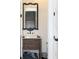 Charming bathroom with dark vanity and a unique mirror at 2293 Eldorado Ct, St Cloud, FL 34771