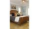 Bright bedroom with wood bed frame and light blue walls at 2293 Eldorado Ct, St Cloud, FL 34771