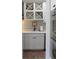 Butler's pantry with white shaker cabinets, quartz countertops, and wine storage at 2293 Eldorado Ct, St Cloud, FL 34771