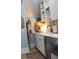 White shaker cabinets, wine storage, and a farmhouse sink in this butler's pantry at 2293 Eldorado Ct, Saint Cloud, FL 34771