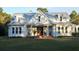 White farmhouse with metal roof, front porch, and landscaping at 2293 Eldorado Ct, St Cloud, FL 34771
