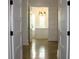 Bright hallway with polished concrete floors and white doors at 2293 Eldorado Ct, St Cloud, FL 34771