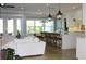 Open floor plan connecting kitchen and living room with hardwood floors at 2293 Eldorado Ct, St Cloud, FL 34771