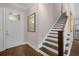 Staircase with dark wood and white risers, hardwood floors, and white door at 2517 Ridge Ave, Orlando, FL 32803