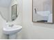 Small bathroom with pedestal sink and framed art at 2778 Puffin Pl, Davenport, FL 33837