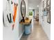 Bright entryway with tiled floor, console table, mirror, and coat hooks at 2786 Puffin Pl, Davenport, FL 33837