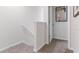 Upstairs hallway with carpet flooring and a door at 2794 Puffin Pl, Davenport, FL 33837