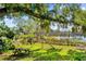 Large backyard with a lake view, playground, and picnic table at 3007 Fayson Cir, Deltona, FL 32738