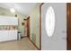 White door with an oval window and adjacent kitchen cabinets at 3007 Fayson Cir, Deltona, FL 32738
