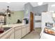 Kitchen with white cabinets, appliances, and a corner sink at 3007 Fayson Cir, Deltona, FL 32738