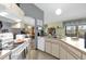 Galley kitchen with white cabinets and view of dining room at 3007 Fayson Cir, Deltona, FL 32738