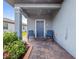 Front porch with blue rocking chairs and lush greenery at 3570 Southern Cross Loop, Kissimmee, FL 34744