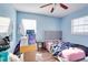 Blue bedroom with gray headboard, wood floors, and window at 4213 Seybold Ave, Orlando, FL 32808