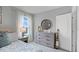 Bright bedroom with a dresser and beach-themed bedding at 463 Taylor Groves Dr, Lake Wales, FL 33853