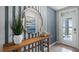 Bright and airy entryway with wood console table and large circular mirror at 463 Taylor Groves Dr, Lake Wales, FL 33853