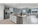 Modern kitchen with island, stainless steel appliances, and view to dining area at 463 Taylor Groves Dr, Lake Wales, FL 33853
