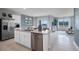 Modern kitchen with island, stainless steel appliances, and view to dining area at 463 Taylor Groves Dr, Lake Wales, FL 33853