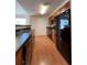 Modern kitchen with wood cabinets, black appliances, and dark countertops at 6648 Time Square Ave # 104, Orlando, FL 32835