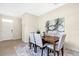 Bright dining room with a wooden table, six chairs, and an area rug at 7836 June Ln, Wildwood, FL 34785